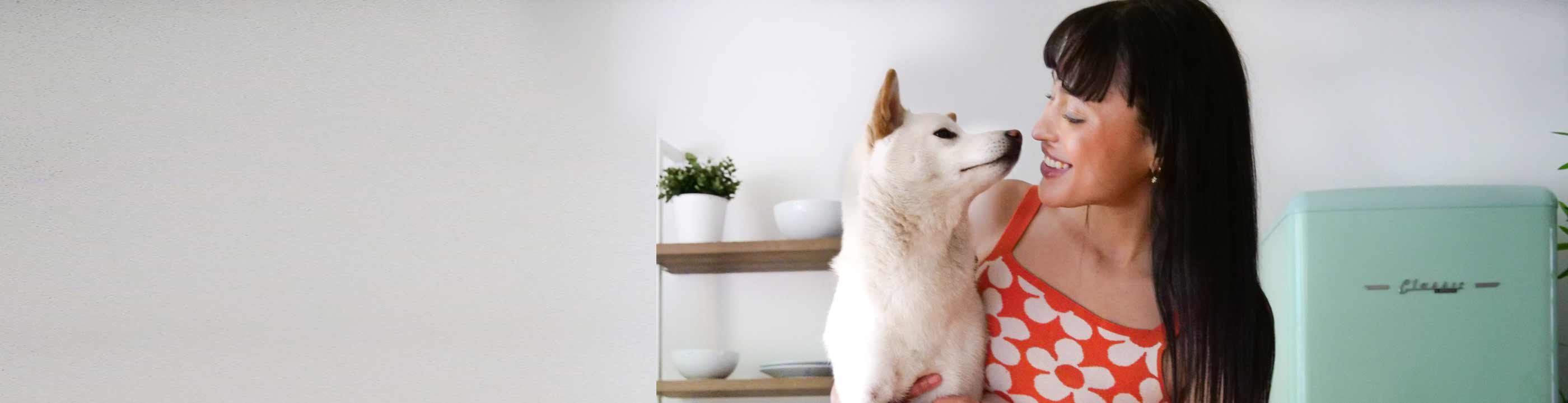 woman and her fresh pup looking lovingly at each other with oxyfresh pet water additive and a water bowl on the counter in front of them