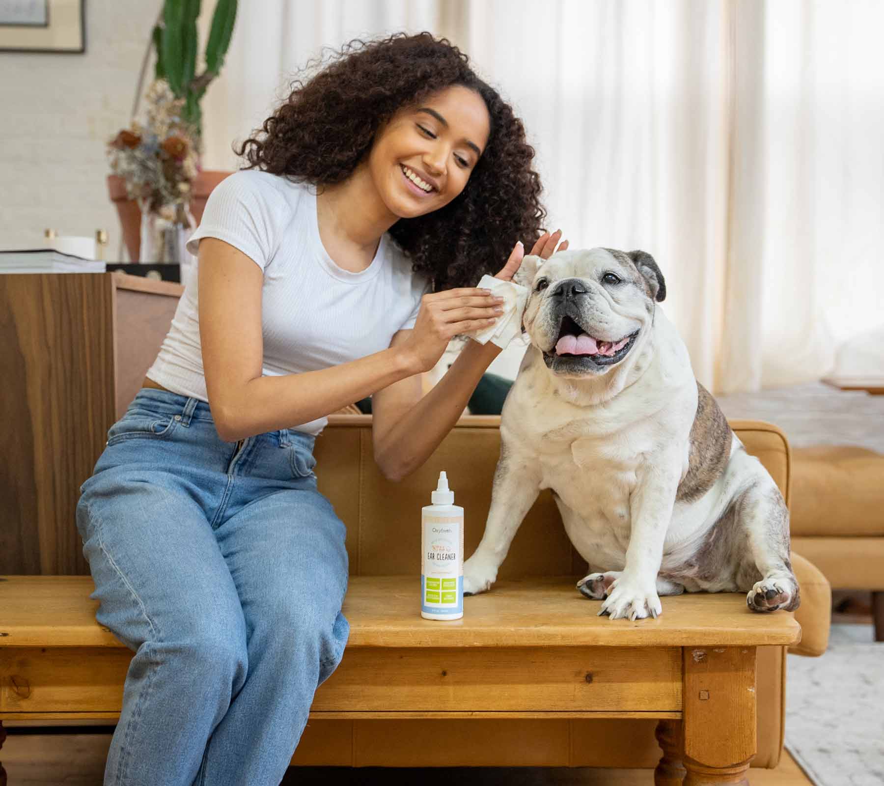 woman-gently-cleaning-smiling-dogs-ears-with-oxyfresh-pet-ear-cleaner