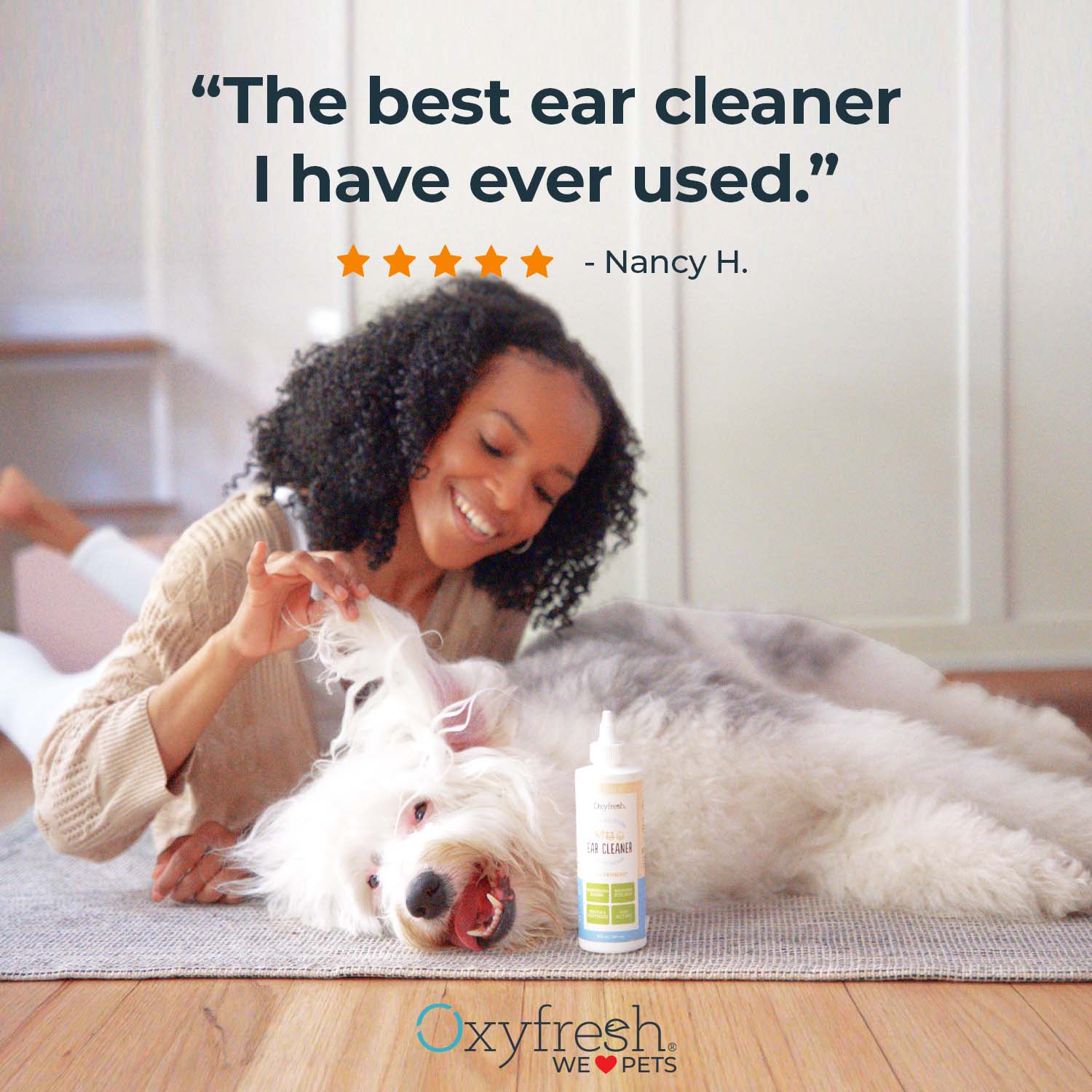 oxyfresh pet ear cleaner dog ear cleaning solution image of woman holding up smiling dog's ear with a review that says the best ear cleaner i have ever used by nancy h. 